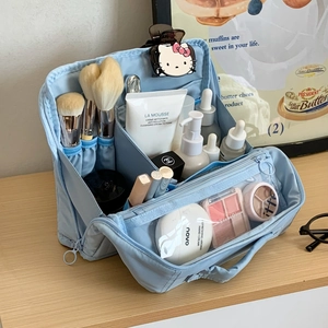 Detail view of large capacity light blue makeup bag with multi-layer storage compartments