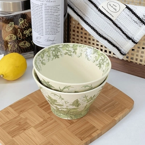 Detailed view of lily of the valley ceramic bowls on a wooden tray for home dining