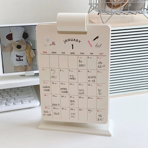 Detail of 2026 desk calendar showing monthly grid and handwriting on cream paper