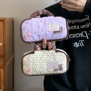 Close-up of quilted high-capacity pencil case with star patterns and carrying handle