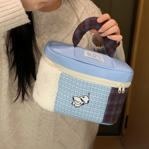 Detail of blue PU makeup bag with white plush side panels and cute puppy print