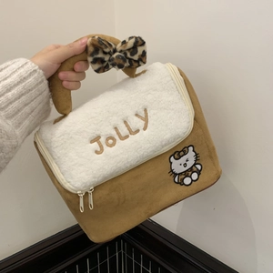 Detail of suede makeup bag with faux shearling flap, leopard bow and cartoon embroidery