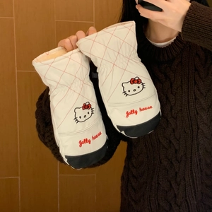 Close-up of white padded mittens with Hello Kitty embroidery and red quilted pattern