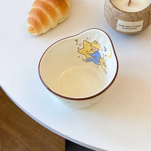 Detail of ceramic Little Prince salad bowl with unique irregular edge and warm illustration