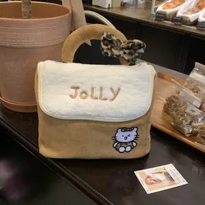 Detail of suede makeup bag with JOLLY embroidery, plush trim and leopard print bow