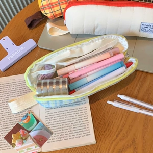 Detail view of large capacity plaid pencil case interior with mesh pockets and pen holders