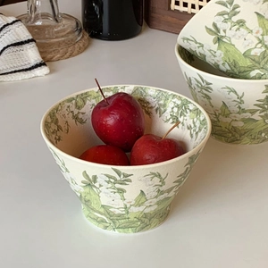 Close-up of ceramic lily of the valley bowls featuring fresh floral patterns and apples
