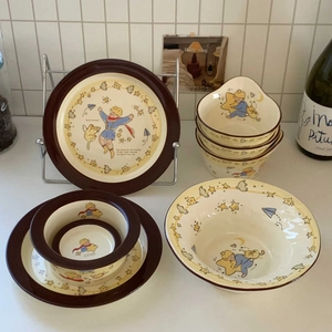 Detail of Le Petit Prince ceramic tableware set showing stacking bowls and star patterns