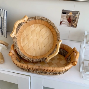 Detail of two-piece woven storage trays with hemp rope handles and natural wood finish