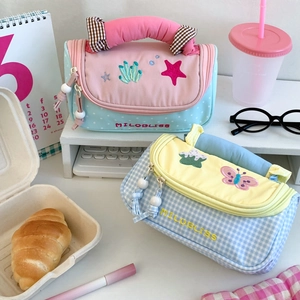 Detail of high-capacity stationery bags with starfish and butterfly embroidery and soft handles
