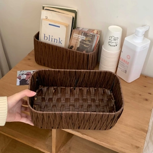 Close-up of deep brown faux rattan storage baskets with sturdy internal metal frames