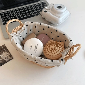 Woven storage basket with polka dot fabric liner for organizing desktop cosmetics