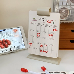 Detail of 2026 desk calendar with monthly planning grid and minimalist cream stand
