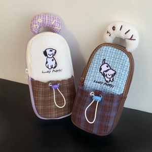 Close-up of Lucky Puppy storage case featuring plush fabric and JOLLY handle embroidery
