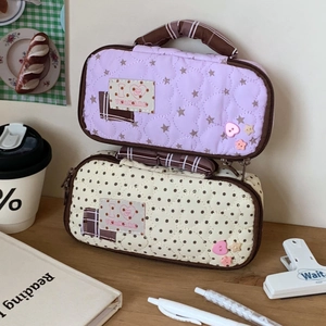 Cute quilted stationery bags in lilac and cream colors with heart stitching and handles