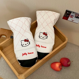 Detail of white quilted mittens with kitty embroidery and anti-slip palm for skiing