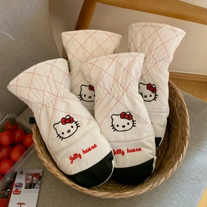 Close-up of Hello Kitty embroidery and red quilted stitching on warm white ski gloves