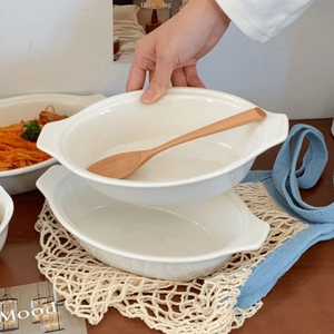 Detail view of white ceramic oval baking dish with handles for salad and pasta
