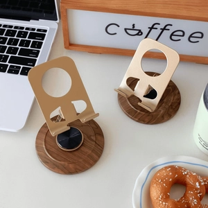 Close-up of wood and metal phone stands featuring a 360-degree rotating base