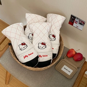 Close-up of white quilted ski mittens with cute kitty embroidery and red grid pattern