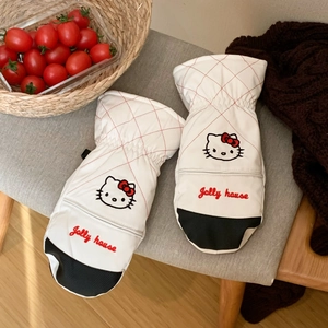 Detail of white quilted mittens with red grid patterns and cute cartoon cat embroidery