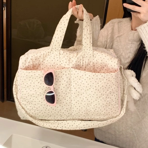 Quilted floral tote bag with pink piping detail and a cute plush rabbit charm