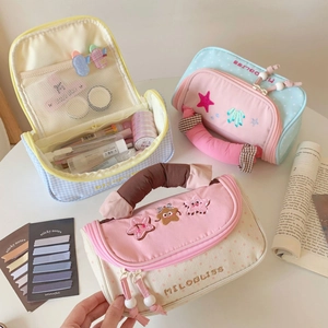 Close-up of quilted pencil case with star embroidery and spacious layered storage
