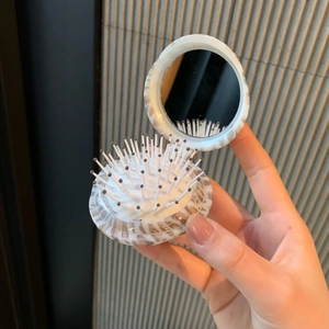 Portable folding hairbrush with mirror featuring a stylish leopard pattern case