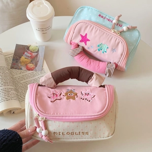 Macro detail of plush corduroy pencil bag with star embroidery and soft handle