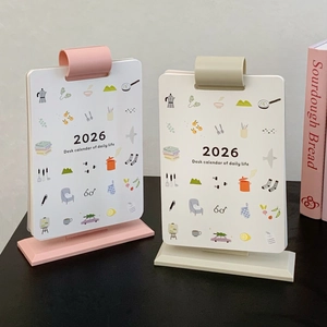 Detailed view of the 2026 vertical desk calendar with pink and beige covers and cute icons
