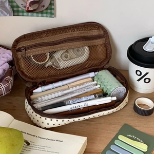 Macro shot of large capacity beige polka dot pencil case with inner mesh pocket storage