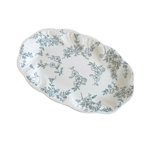 French vintage ceramic oval dinner plate with blue floral embossing and scalloped edges