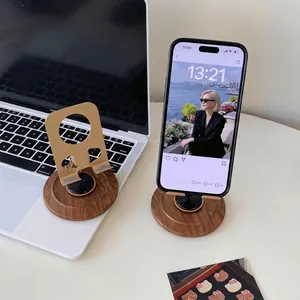 Walnut wood and gold metal desktop phone stand with 360-degree rotation and sleek design