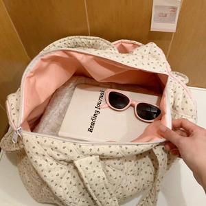 Close-up of quilted floral tote bag interior with pink lining and spacious capacity