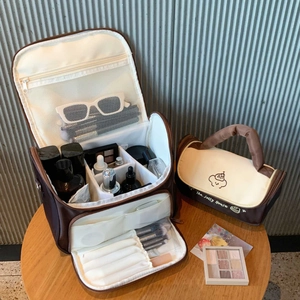 Internal compartments of a large capacity makeup bag with brushes and cosmetics