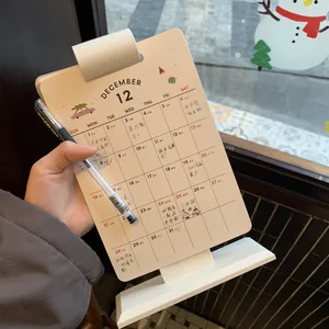 Close-up of 2026 vertical desk calendar with monthly planner pages and holiday illustrations