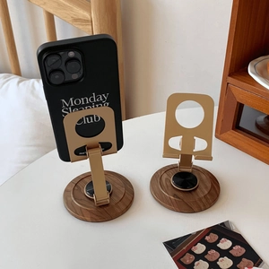 Detail of vintage wood and metal phone stand showing 360-degree rotation base