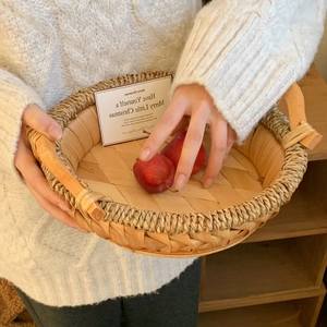 Handwoven round rattan fruit basket for home decor with natural rustic aesthetic style
