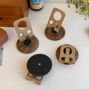 Macro view of aluminum phone stand with walnut wood base and non-slip bottom pads