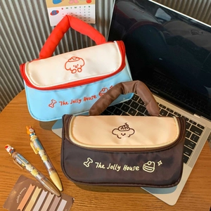 Detail of embroidered puppy cosmetic bags with sturdy handles in blue and brown canvas