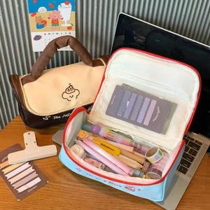 Close-up of large capacity patchwork puppy makeup bags with mesh pockets on a wooden desk