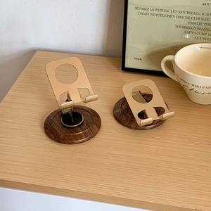 Rotating wood and gold metal desktop stand for phone or tablet in two folding positions