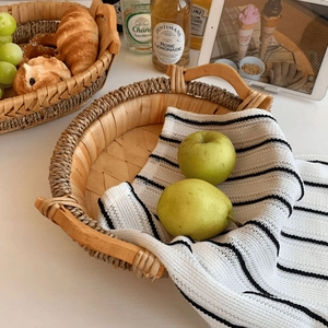 Macro view of woven rattan fruit basket with handles and natural texture detail