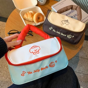 Detail of the cushioned handle and zipper on the puppy pattern makeup bags