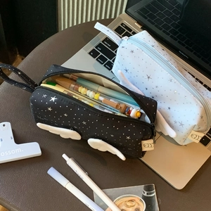 Detail of star-patterned pencil cases with wings showing large storage capacity