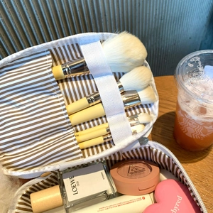 Detail view of large capacity makeup bag with inner brush slots and cosmetic organizers