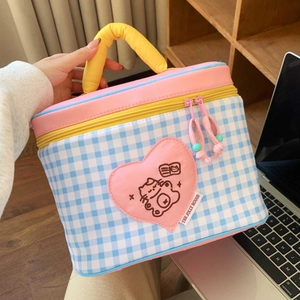 Detail of insulated lunch bag featuring blue checkered pattern and pink heart cat patch