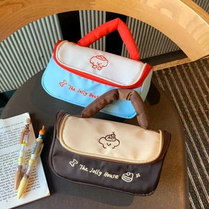Detail of multi-functional makeup bags with dog embroidery and The Jolly House branding