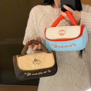 Detail view of stylish quilted makeup bags with cute puppy prints and sturdy handles