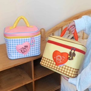 Close-up of cute cartoon thermal lunch bags featuring cat and dog heart patches